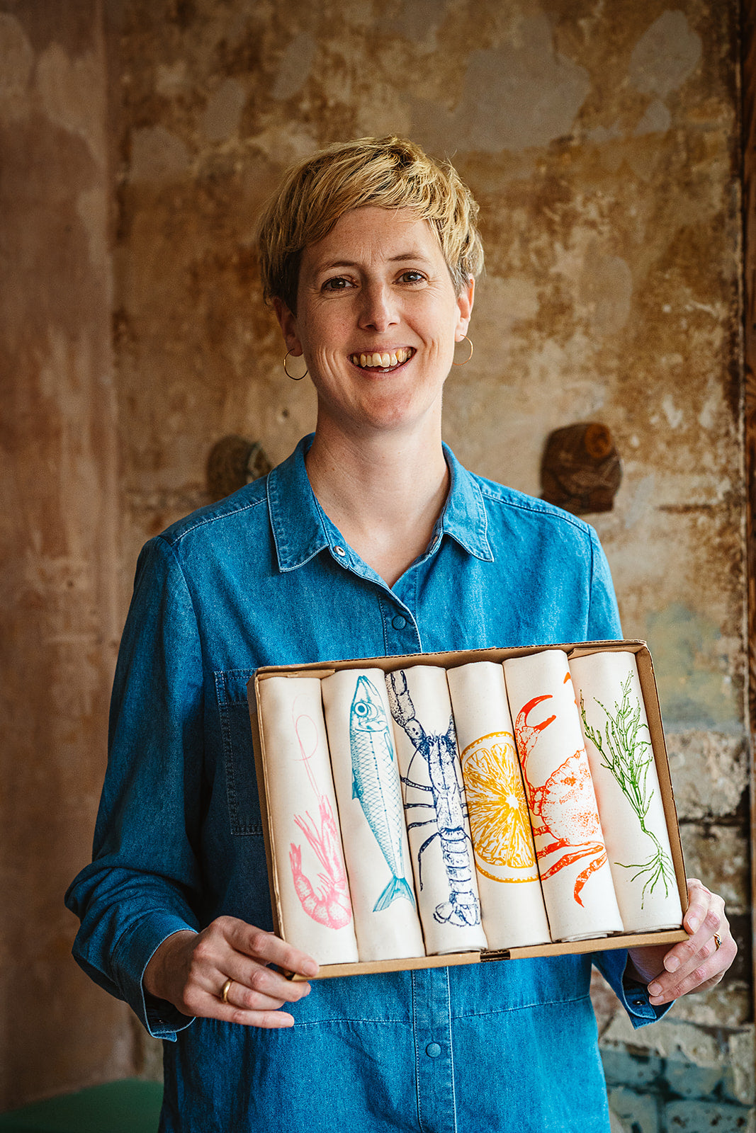 Lottie Day seafood collection featuring handprinted fish and lobster napkins and tea towels inspired by Norfolk’s coastal charm