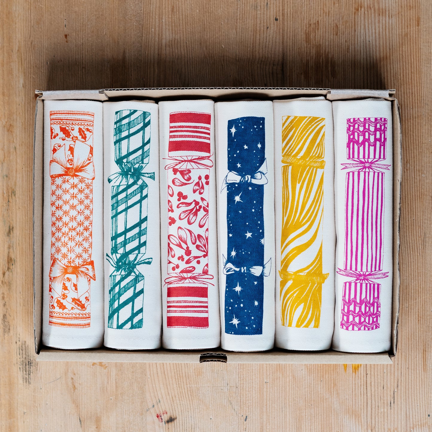 Christmas Cracker napkin set by Lottie Day – six cotton napkins with festive prints and hidden surprise designs