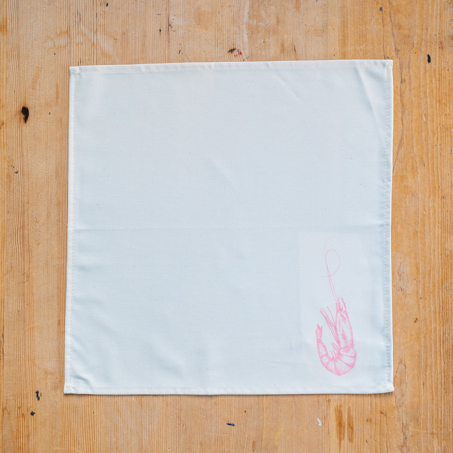 Seafood napkin gift set by Lottie Day featuring handprinted crab, blue lobster, prawn, mackerel, samphire and lemon illustrations on cotton napkins